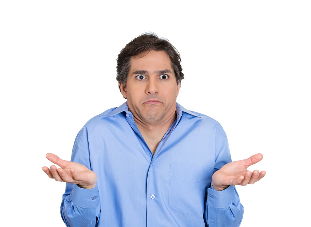 Closeup portrait of dumb, clueless, funny looking young man, arms out asking whats problem, who cares, so what, I dont know, isolated on white background. Negative human emotions, facial expressions-1